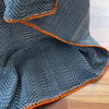 Trambia throw blanket with stitched edges